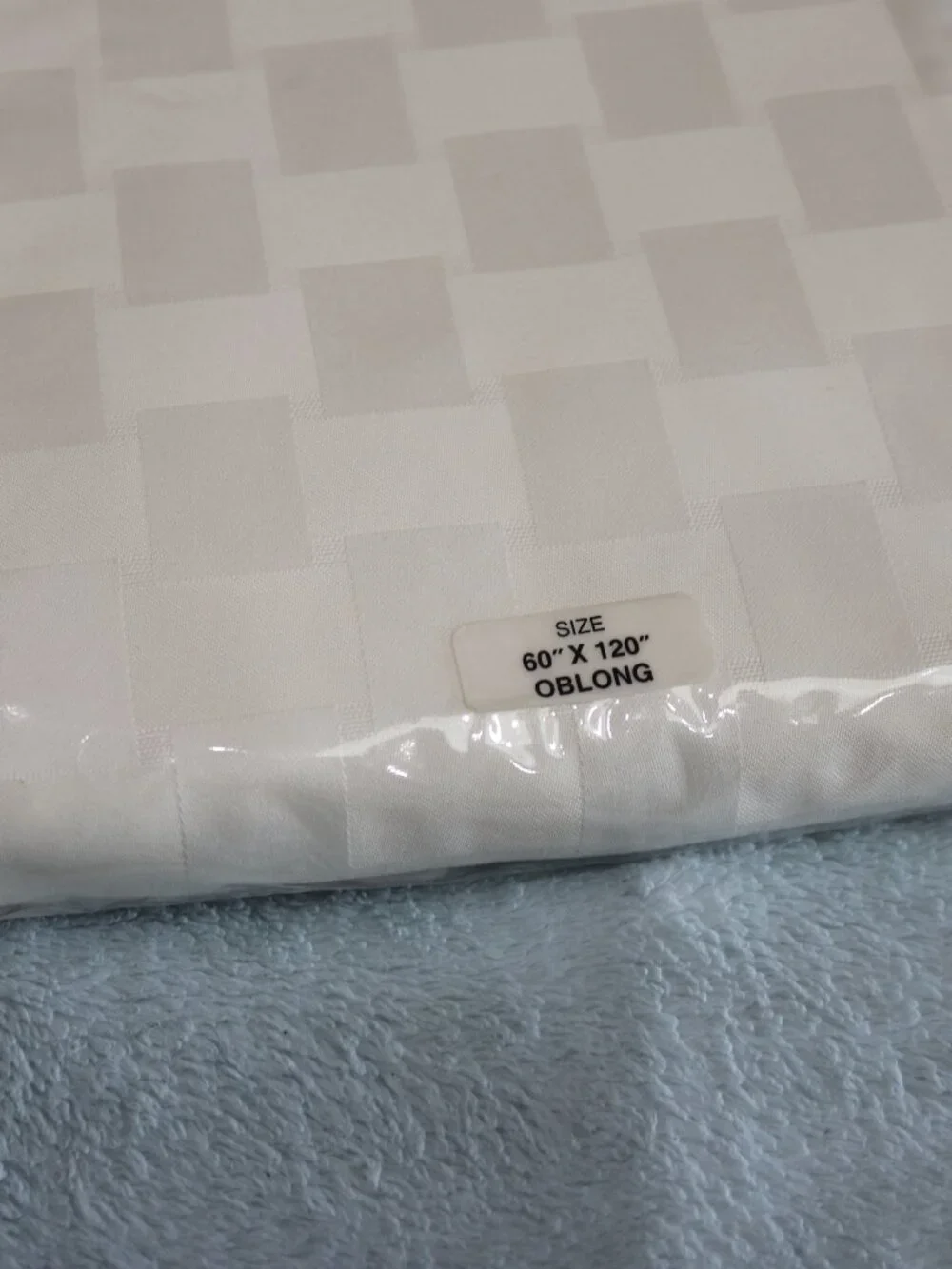 Reflections Microfiber cream checkered tablecloth. New. 60x120.